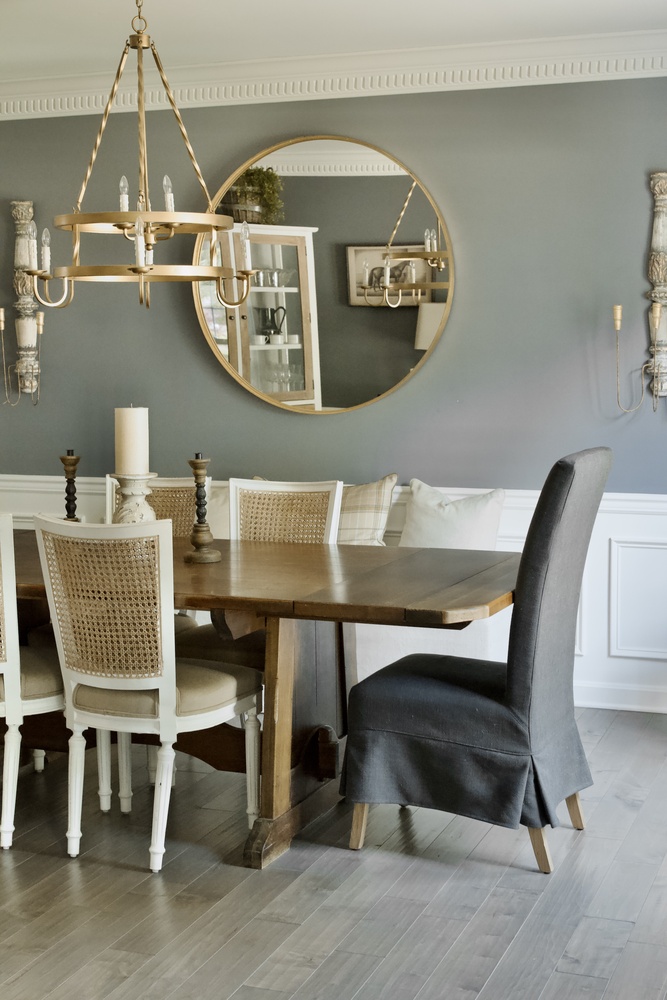 Dining room remodel with round mirror and gold chandelier by Trade Works Remodeling in Louisville, KY