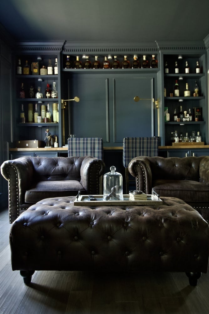 Sophisticated bourbon lounge with leather seating in a custom home by Trade Works Remodeling in Louisville, KY