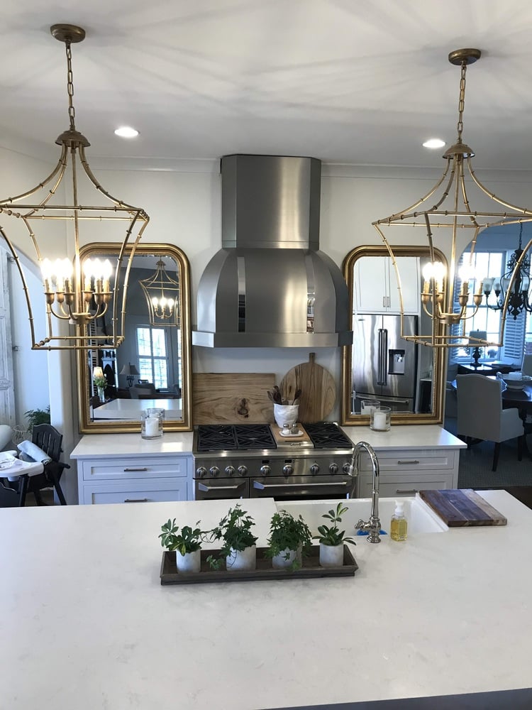Luxury kitchen remodel with stainless hood and gold lighting by Trade Works Remodeling in Louisville, KY